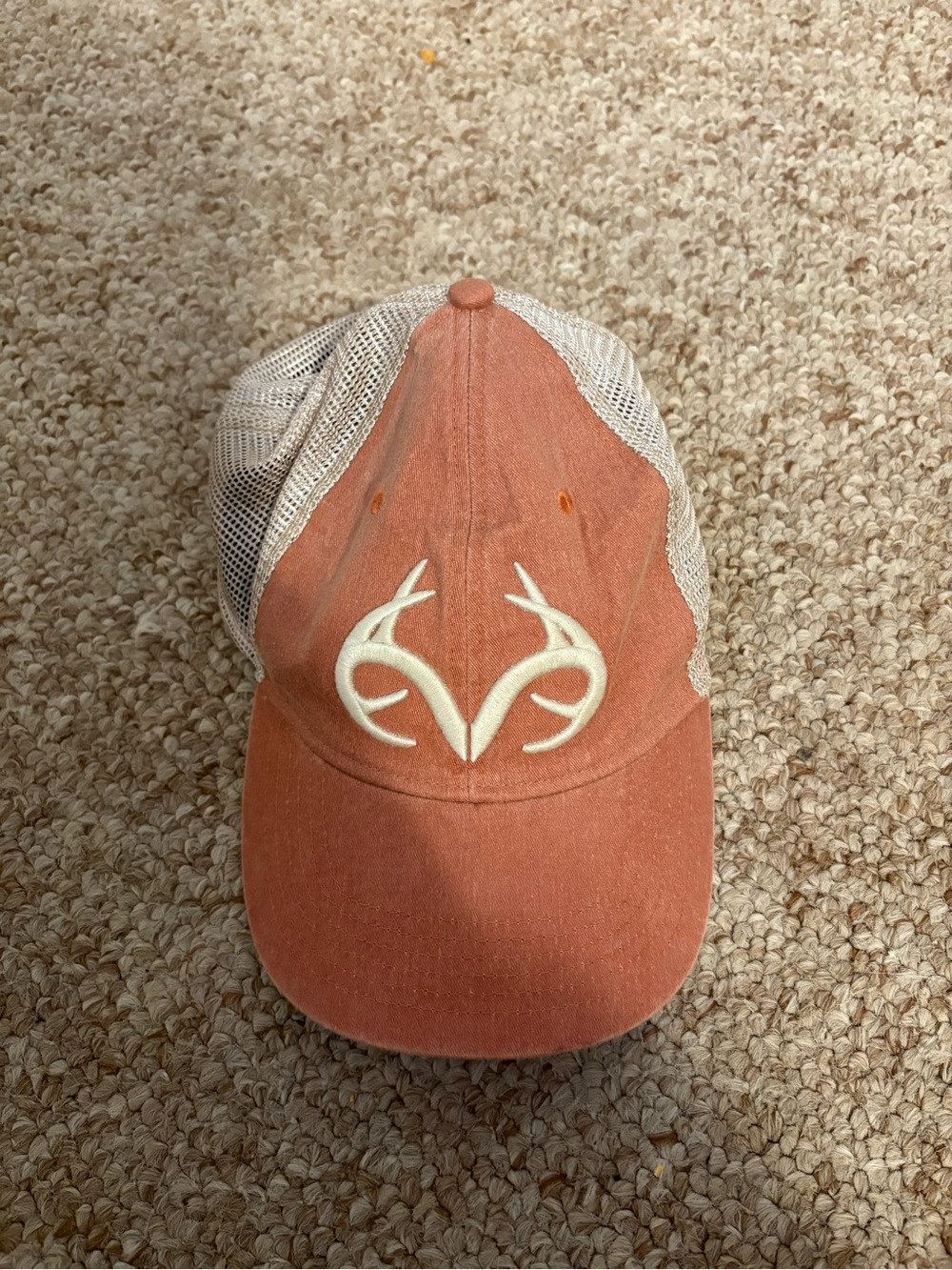 Realtree Rust Orange and Cream Mesh Trucker Hat with Antler Logo